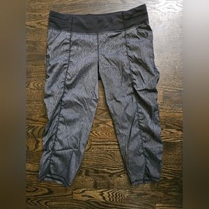 LUCY gray capri pants with ruching on sides of legs.